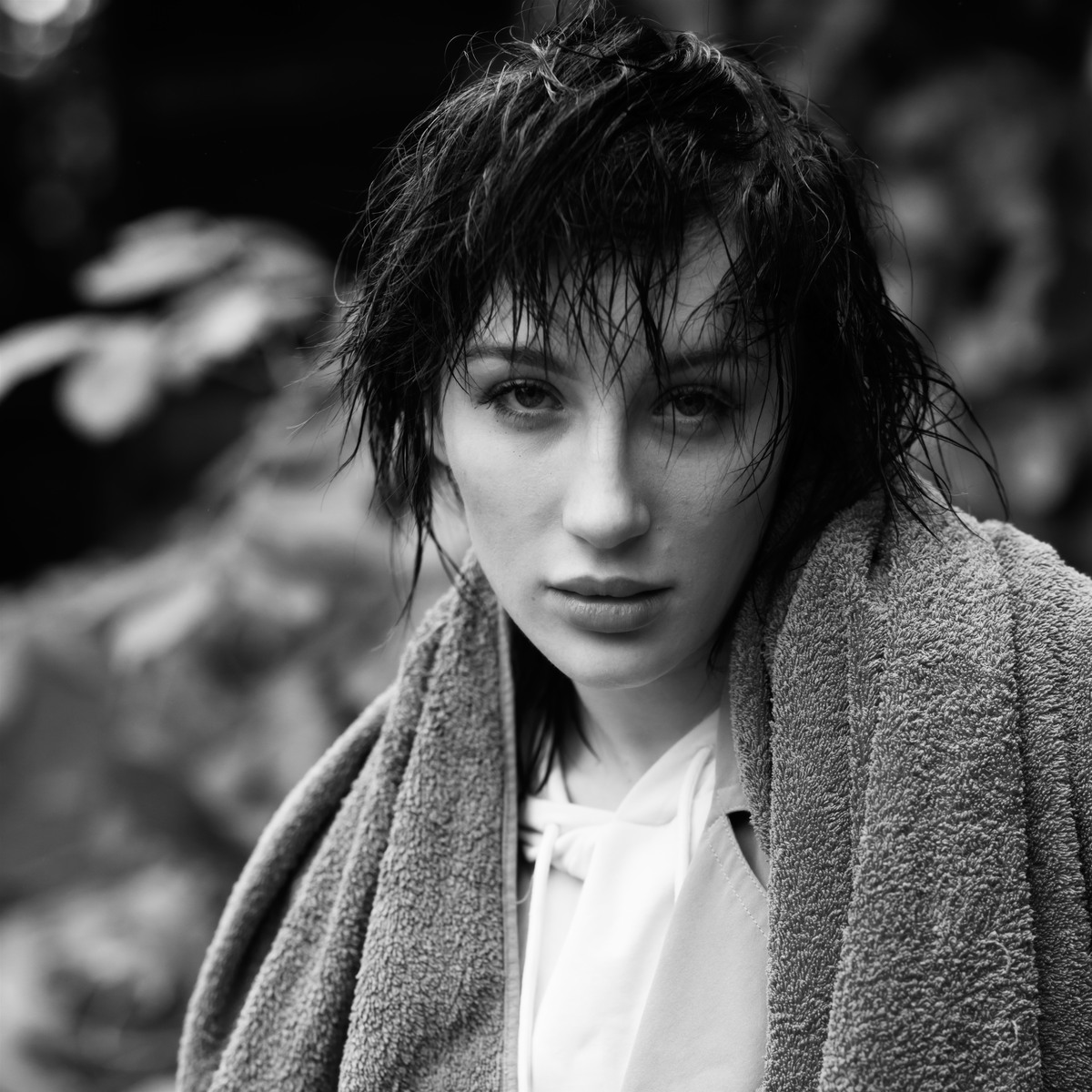 Black-and-white portrait of a woman with wet hair wrapped in a towel.